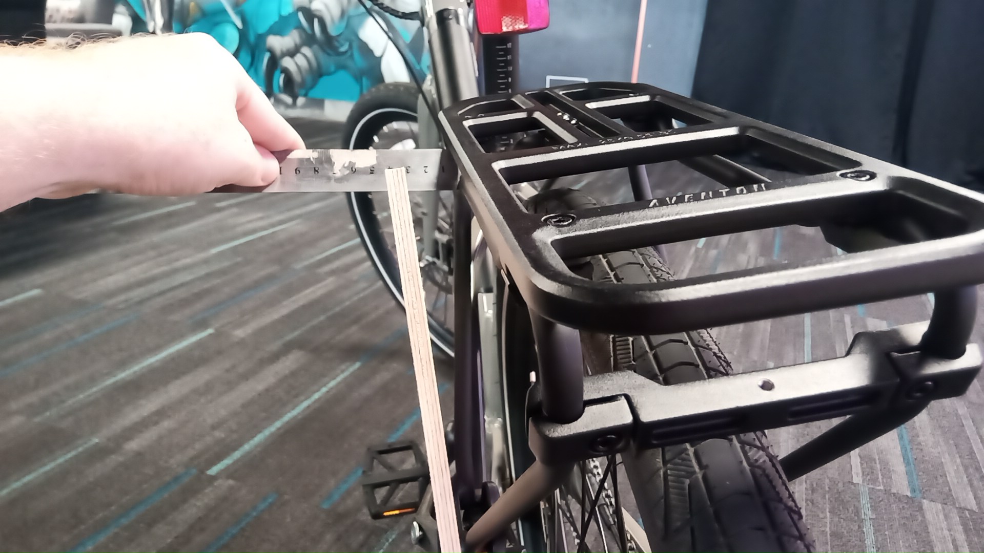 Measuring the rack with a ruler against a plywood strip